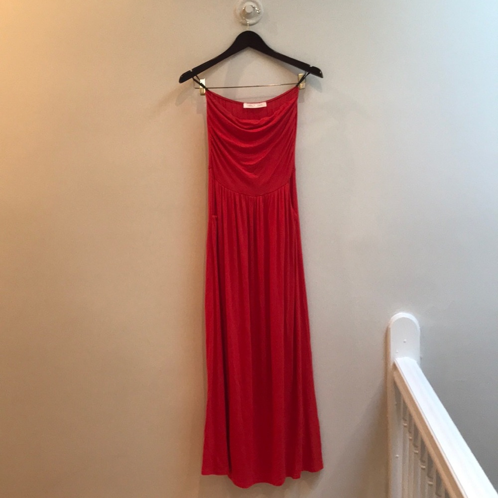 Red strapless maxi dress with pockets.